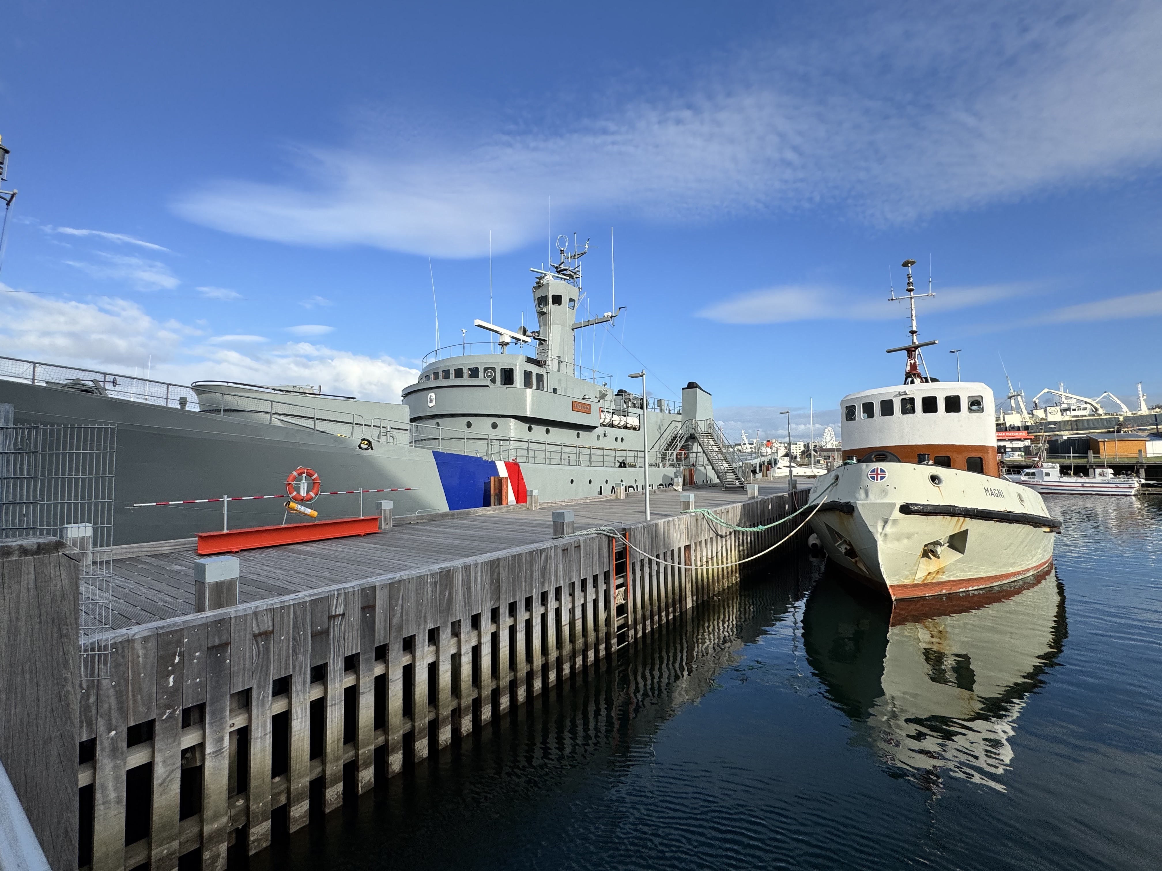 Boats docked in Reykjavik's old harbor under blue skies
