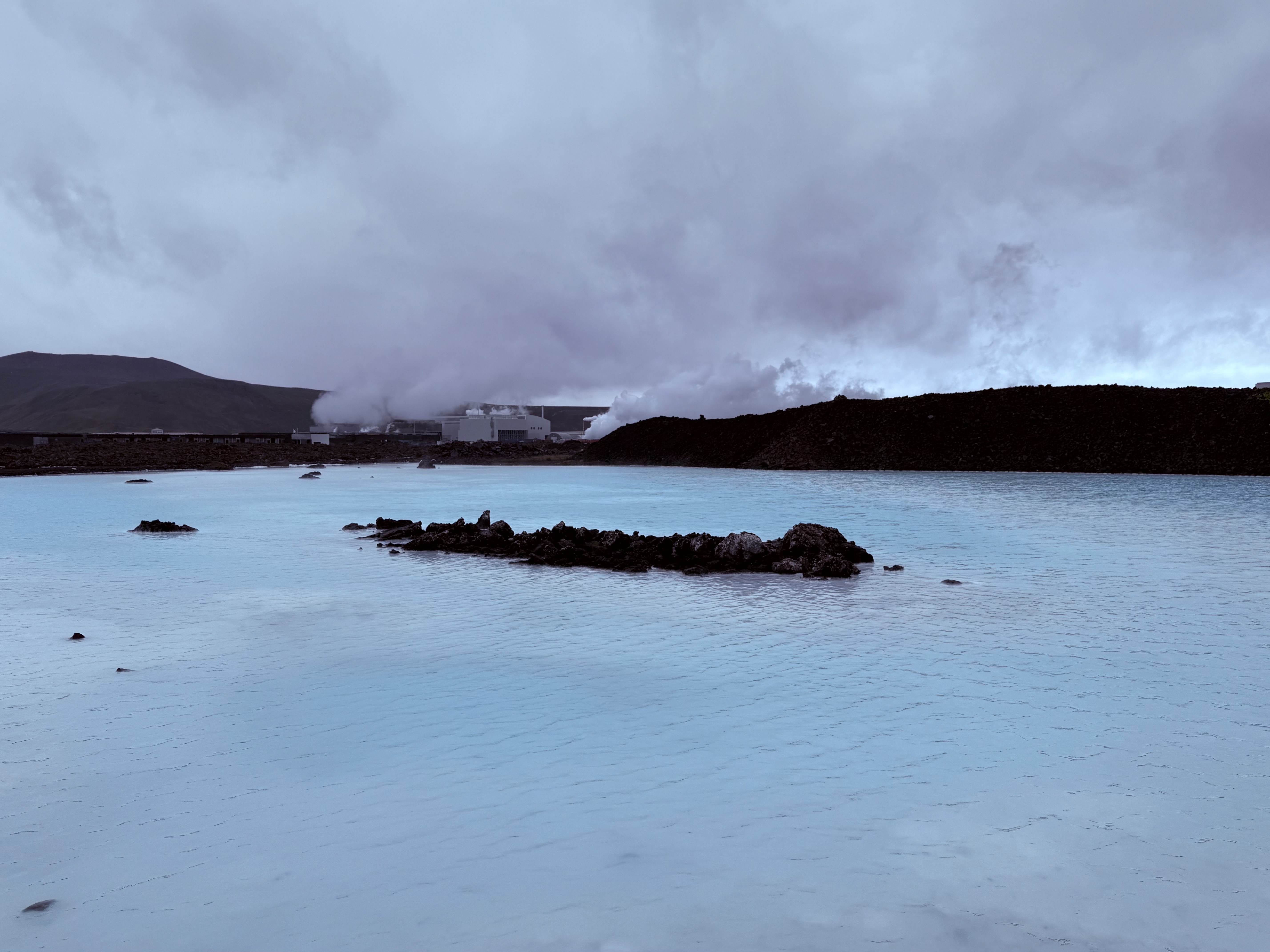The milky blue waters of the Blue Lagoon under dramatic clouds