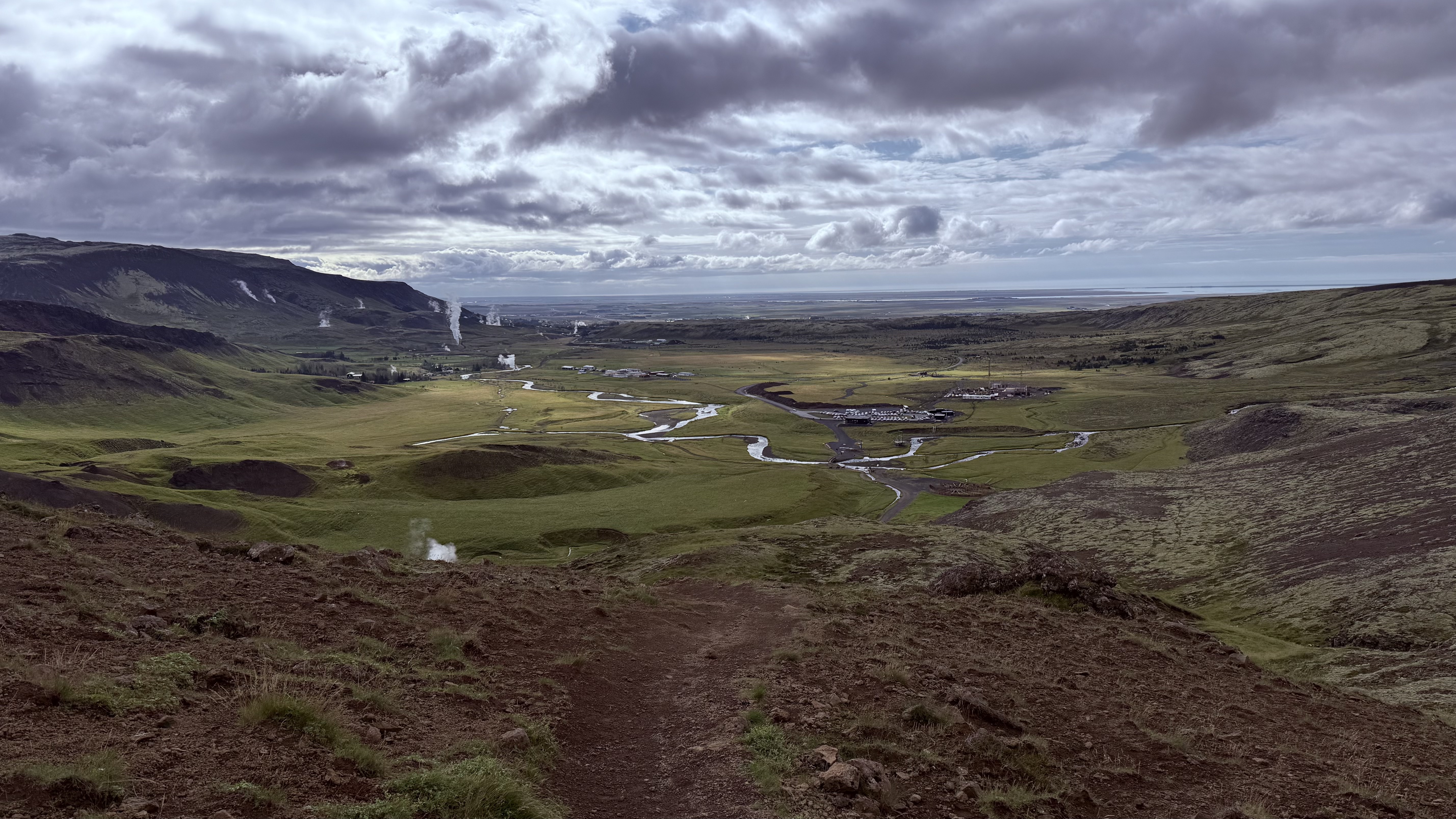 Reykjadalur valley with winding streams and geothermal steam