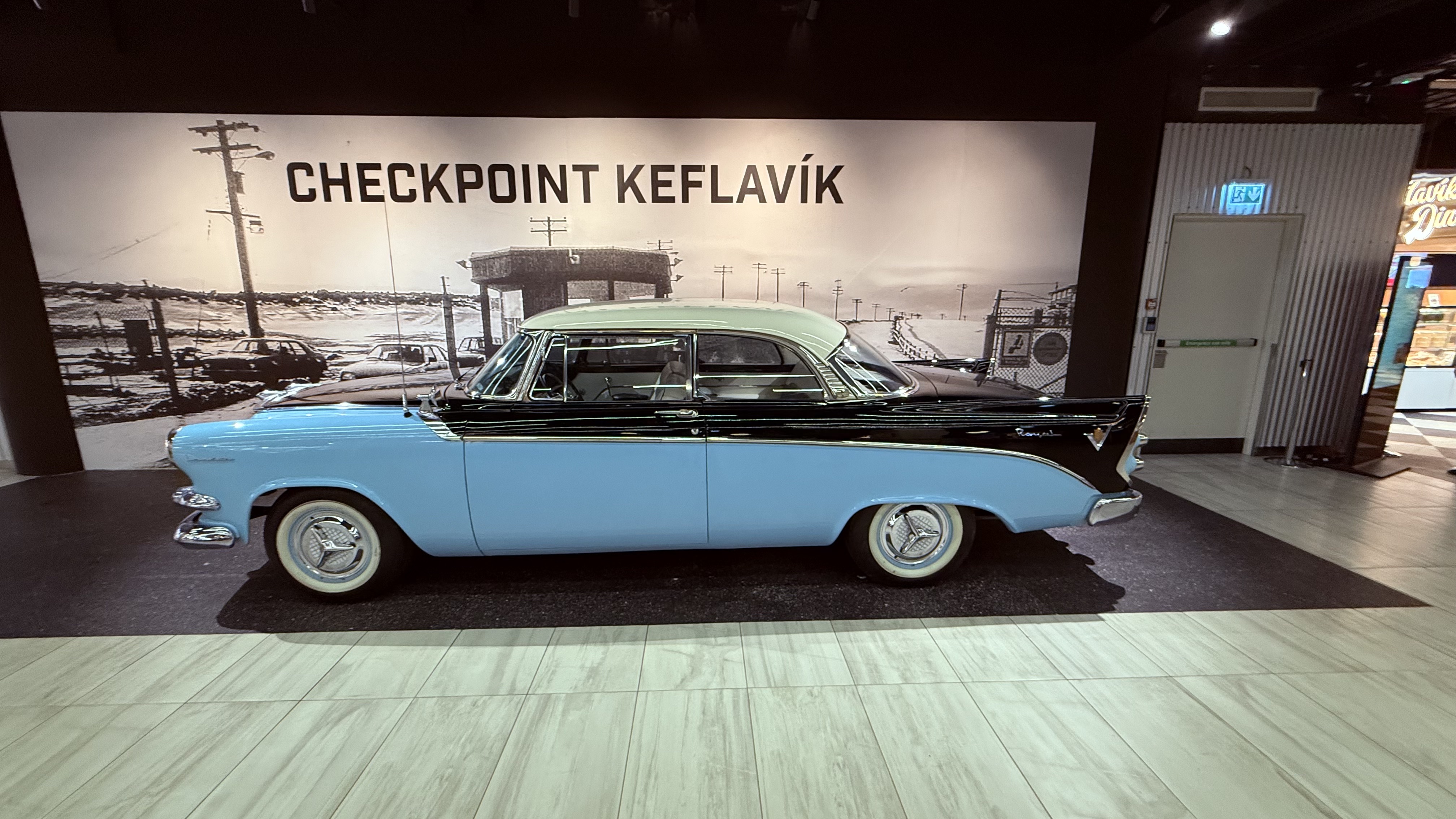 Checkpoint Keflav&iacute;k &mdash; vintage car display inside the airport terminal