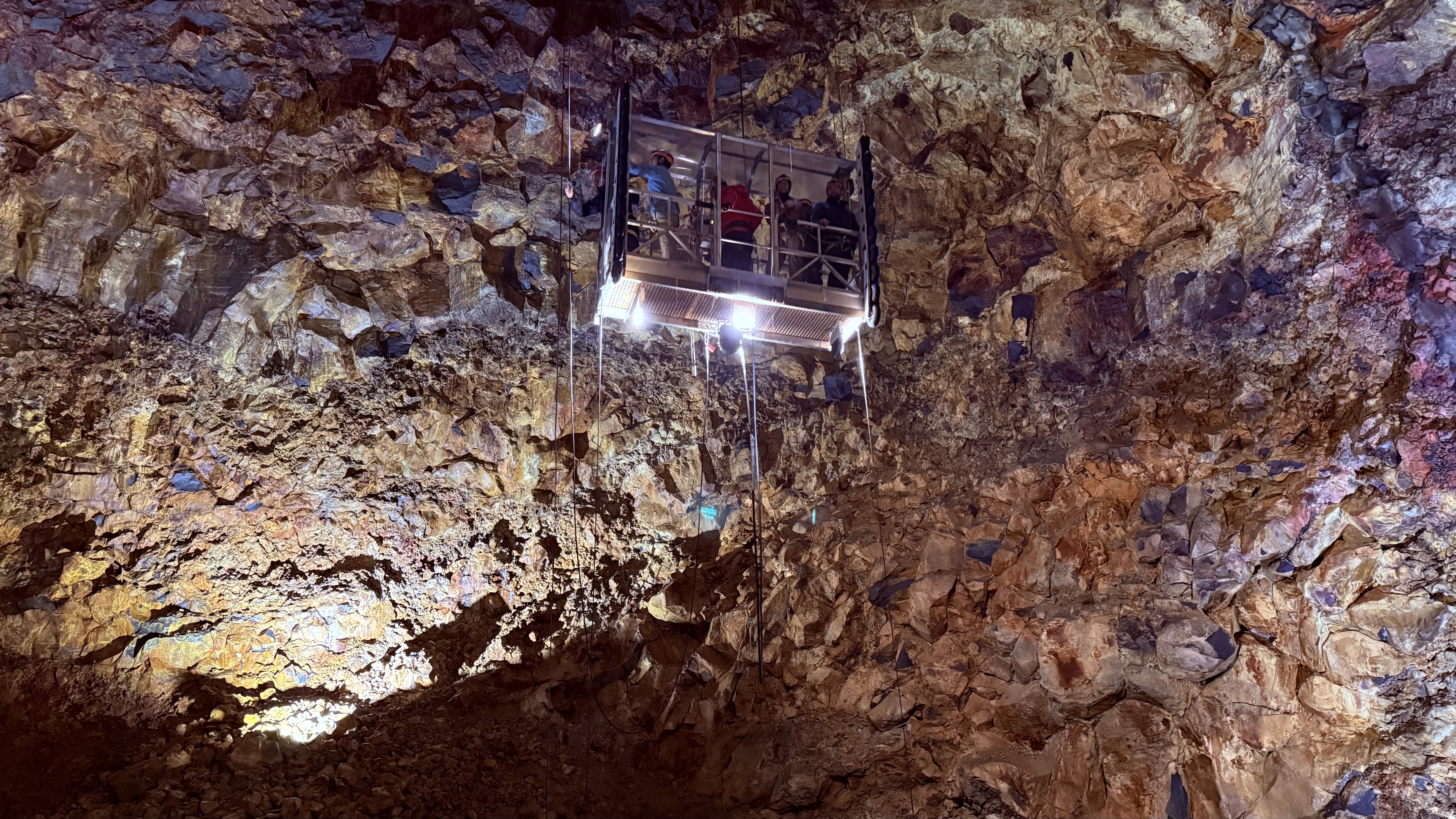 The magma chamber walls glow with mineral colors