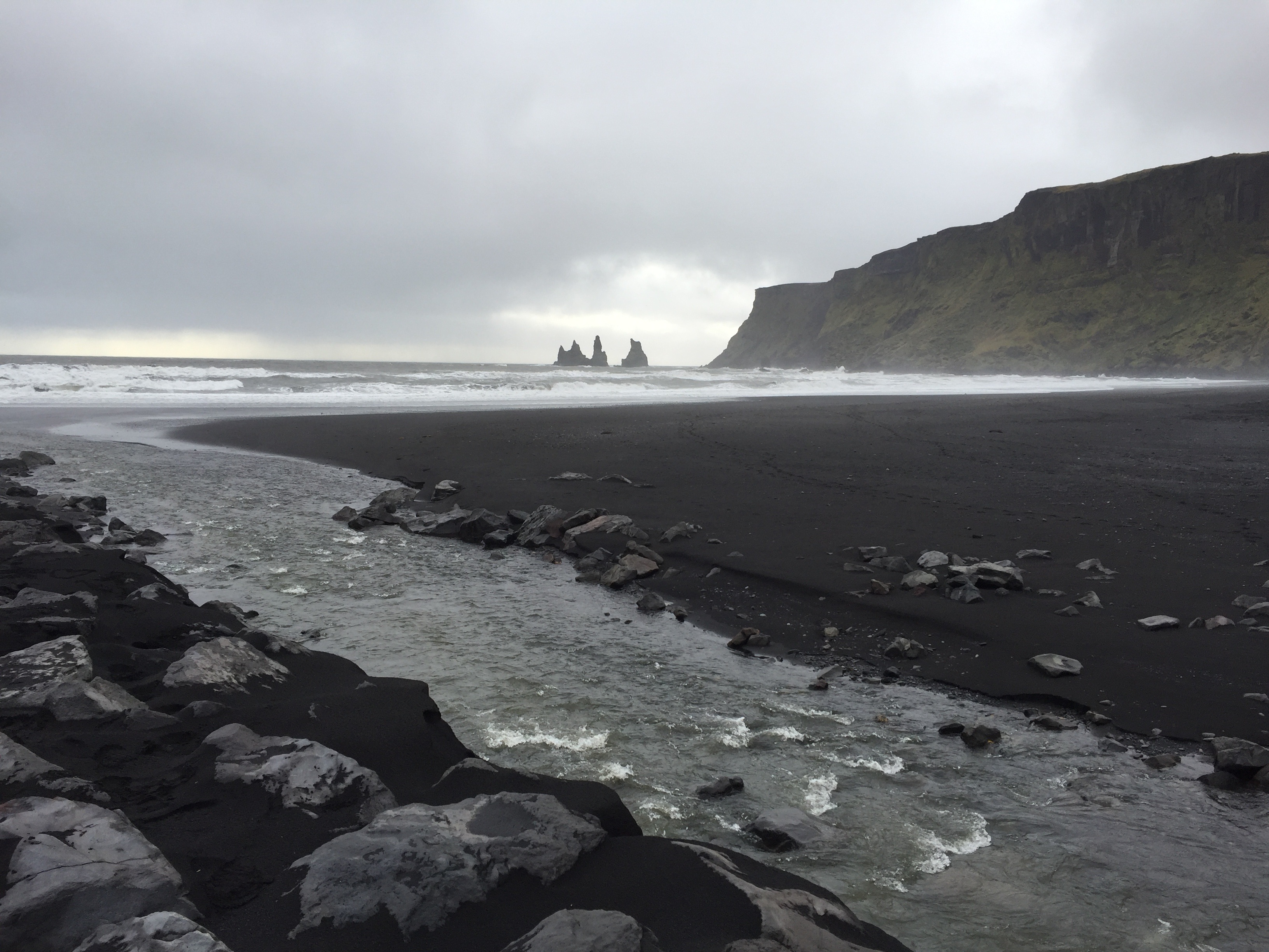 Black-sand beach at V&iacute;k with sea stacks and crashing waves