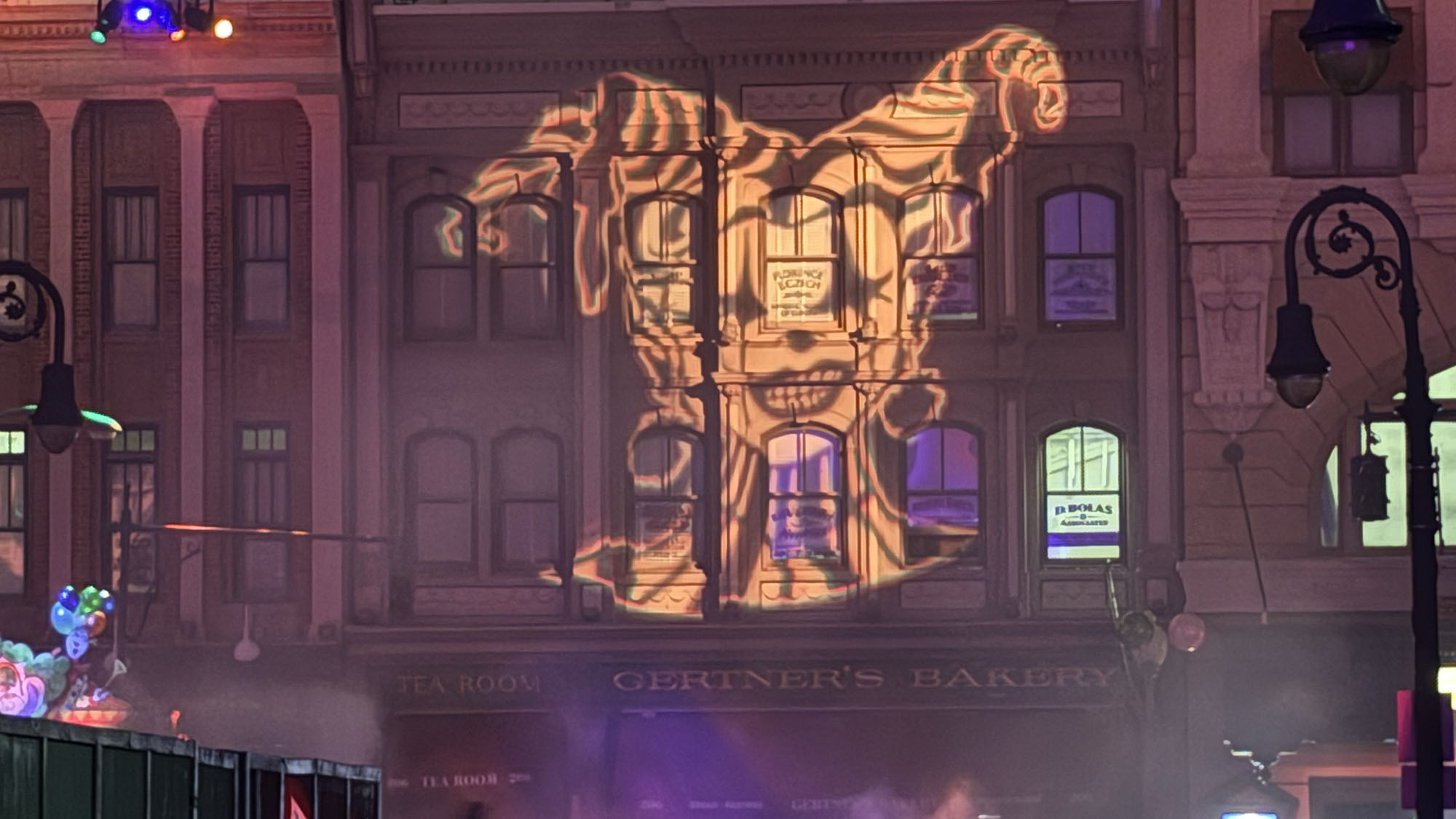 A clown projected onto a New York street facade in Downtown Clowntown